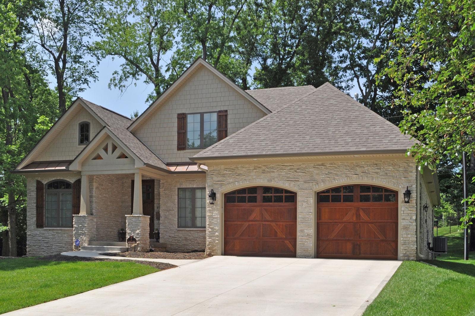 Lansdowne plan elevation with stone and wood garage doors